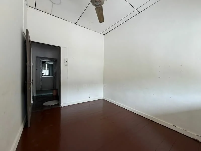 Room features: white painted walls, wooden flooring, ceiling fan, doorway leading to another room, plain ceiling, no visible windows, minimal decor; style: minimalist.