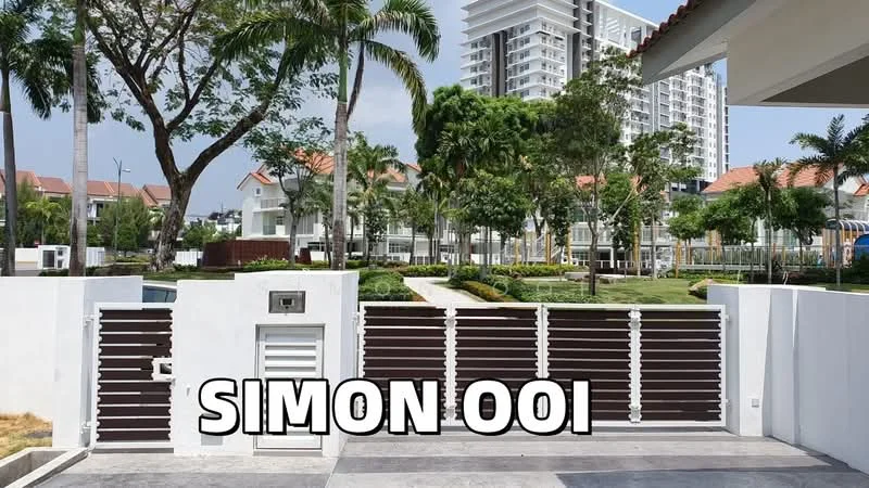 Exterior type: detached bungalow; features: white painted facade, brown wooden gate, manicured lawn, palm trees, landscape garden, surrounded by greenery, multi-storey buildings in background, driveway with interlocking pavers; style: modern.
