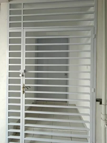 Exterior features: metal security gate with horizontal bars, white painted gate, tiled flooring, plain wall, door with handle, light-colored walls; style: modern.