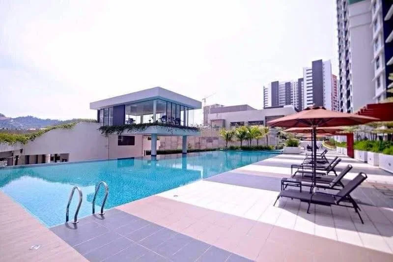 Exterior type: swimming pool deck; features: infinity pool, pool deck with loungers, surrounding greenery, modern clubhouse, paved walkway, umbrellas for shade; style: modern.