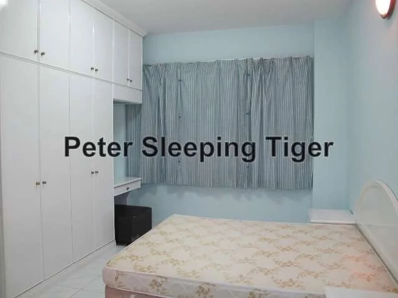 Bedroom features: light blue painted walls, white built-in wardrobes, white bedside table, window with blue striped curtains, white ceiling light, tile flooring, unmade bed with floral-patterned mattress, desk area with chair.