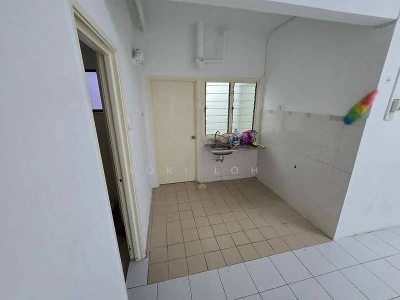 Room features: white painted walls, tile flooring, window with horizontal slats, kitchen countertop, sink, wall-mounted cabinets, door leading to another room, light fixture on ceiling.