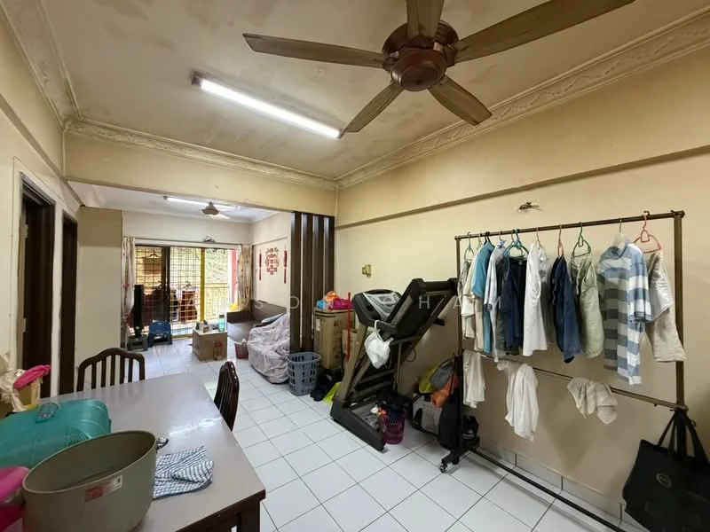 Room features: white painted walls, white tiled flooring, 5-blade ceiling fan, dining table, clothes drying rack, exercise equipment, laundry baskets, boxes, window with grille, natural light from window.