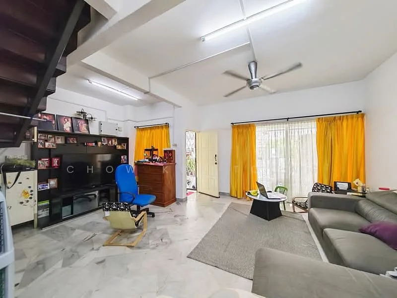 Living features: grey sectional sofa, coffee table, area rug, wall-mounted TV, black TV console, 5-blade ceiling fan with light, white painted walls, marble flooring, large windows with sheer curtains, yellow curtains, decorative wall shelves, wooden staircase; style: modern; view: garden.
