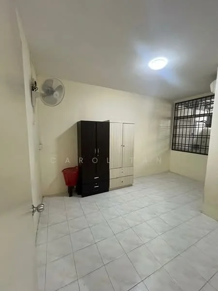Room features: white painted walls, tile flooring, ceiling light, 1 wall-mounted ceiling fan, black wardrobe, beige wardrobe, window with metal grille, red waste bin.