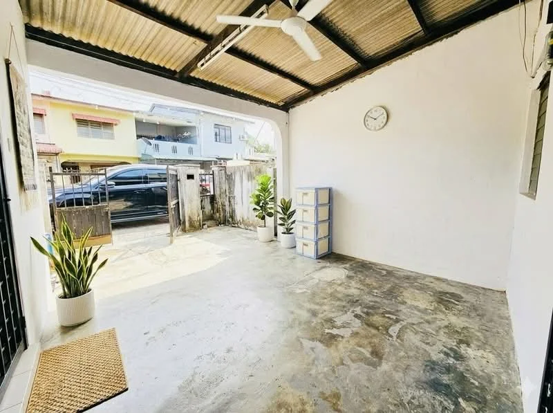 Room features: concrete flooring, white painted walls, exposed ceiling with metal roofing, ceiling fan, wall clock, potted plants, storage cabinets, open layout; style: minimalist.