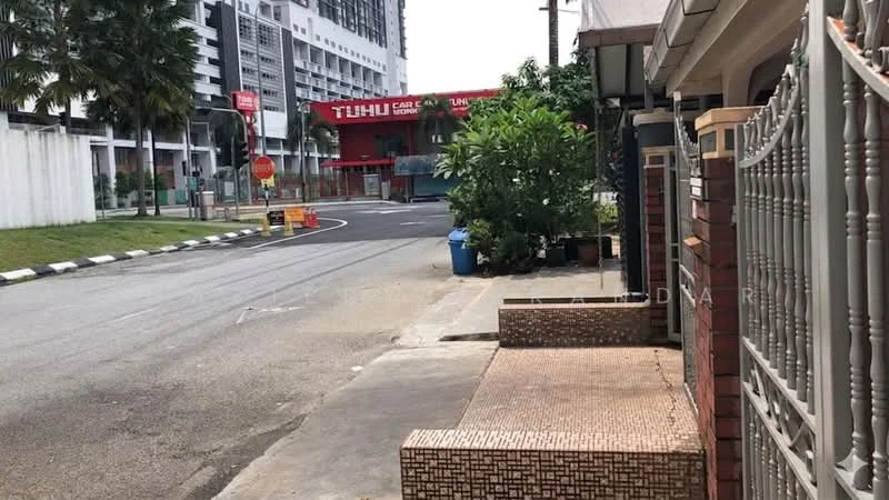 Exterior type: linked terrace house; features: paved walkway, brick facade, metal gate, landscaped garden with shrubs, street view, adjacent to main road, visible commercial building in background; style: modern.