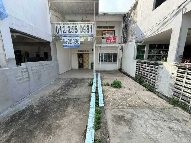 Exterior type: linked terrace house; features: concrete driveway, exposed brick walls, white painted facade, metal gate, front porch area, paved walkway, surrounding greenery, single-storey, signage visible on facade; style: modern.