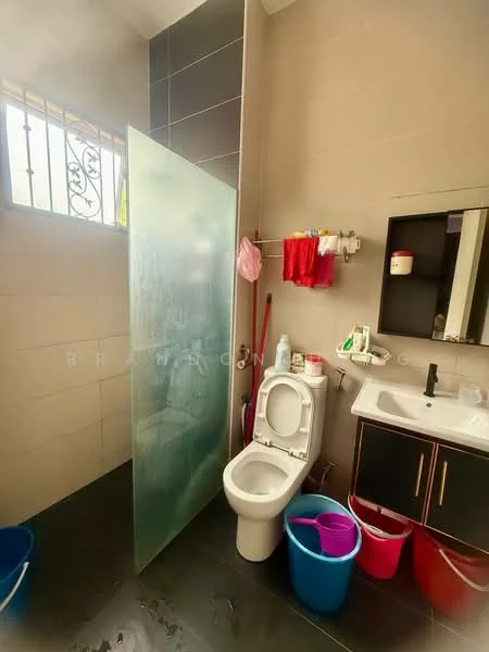 Bathroom features: glass shower enclosure, toilet, single-sink vanity with dark wood cabinet, mirror above sink, black countertop, wall-mounted faucet, tile flooring, grey wall tiles, buckets in various colors, towel rack, window with iron grille; style: modern.