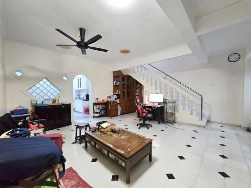 Living features: white painted walls, marble tile flooring, 5-blade ceiling fan, recessed downlights, large window with decorative grille, staircase with white railing, wall clock, area rug with geometric pattern, wooden coffee table, computer desk with chair, sofa in blue upholstery, red upholstered chair, open shelving unit, decorative items on shelves; style: modern. Room features: kitchen area visible in background, wood cabinetry, countertop, appliances visible.