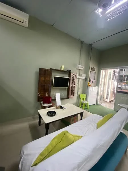 Living features: green painted walls, polished concrete flooring, 5-blade ceiling fan, wall-mounted TV, wooden TV console, white sofa with green cushions, coffee table, sliding glass door, window with sheer curtains, air conditioning unit; style: modern.