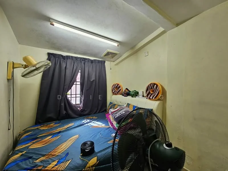 Bedroom features: single bed with colorful bedding, wall-mounted lamp, 2 ceiling fans, black curtains, painted walls in light color, angled ceiling, window with grille, decorative wall art.
