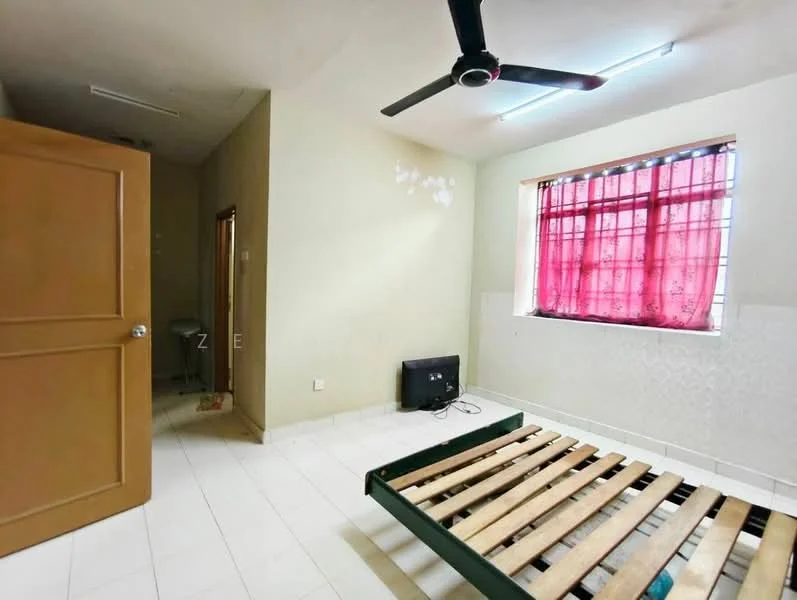 Bedroom features: white painted walls, tile flooring, window with red curtains, ceiling fan, unmade bed frame, wall-mounted TV, door leading to bathroom, light fixture on ceiling.