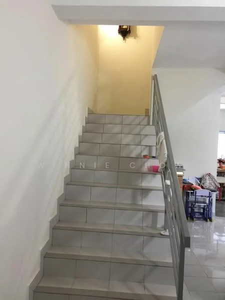 Room features: white painted walls, grey tiled flooring, staircase with grey tiles, metal railing, wall-mounted light fixture, natural light from upper area; style: modern.