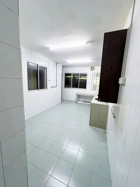 Kitchen features: white tiled walls, light green tiled flooring, single-bowl stainless-steel sink, built-in cabinetry, window with view to outside, fluorescent ceiling lights, countertop space, clock on wall.