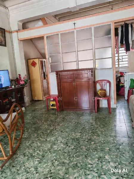 Living features: green patterned tile flooring, wooden cabinet, refrigerator, wooden armchair, TV console, wall-mounted TV, plastic chairs, partition wall with glass panels.