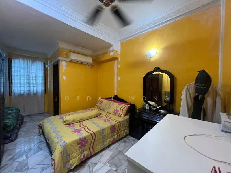 Bedroom features: yellow painted walls, marble flooring, 1 ceiling fan, window with sheer curtains, double bed with floral bedding, wooden wardrobe, dressing table with mirror, decorative wall light.
