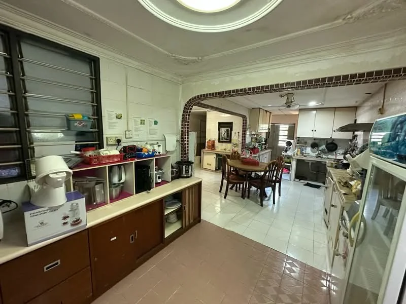 Kitchen features: white tiled walls, cream tiled flooring, kitchen island with countertop, built-in cabinets with wooden finish, stainless-steel sink, chrome pull-down faucet, freestanding refrigerator, microwave, toaster, coffee machine, 4-burner gas hob, exhaust hood, dining table with chairs, window with security bars, recessed ceiling lights; style: traditional.