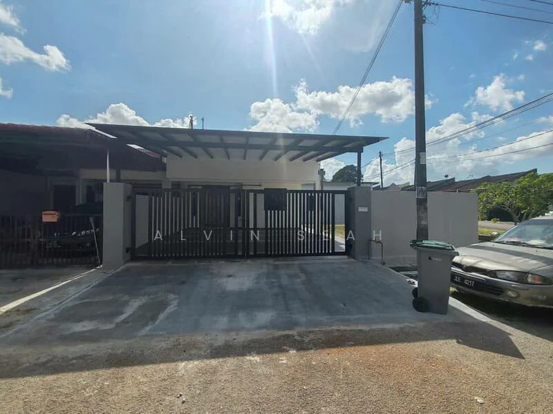 Exterior type: linked terrace house; features: grey painted facade, metal gate, car porch, concrete driveway, flat roof, manicured lawn, surrounded by residential area, visible utility pole, paved walkway; style: modern.