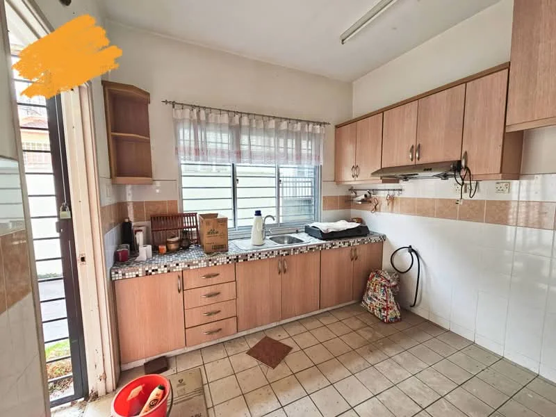 Kitchen features: brown wooden cabinetry, white tiled backsplash, granite countertop, single-bowl stainless-steel sink, chrome pull-down faucet, built-in wall shelf, window with sheer curtains, tile flooring, exposed plumbing, kitchen appliances visible, open layout, light fixture on ceiling.