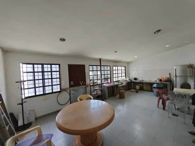 Kitchen features: white painted walls, tile flooring, round wooden dining table, plastic chairs, kitchen cabinets, stainless-steel fridge, sink, window with grid design, door to outside, countertop, open layout.