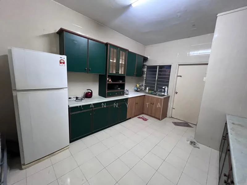 Kitchen features: green cabinetry, white countertop, stainless-steel sink, chrome faucet, freestanding white fridge, built-in oven, ceramic tile flooring, wall-mounted cabinets, open shelving, window with security grill, door leading to outside, light fixture on ceiling.