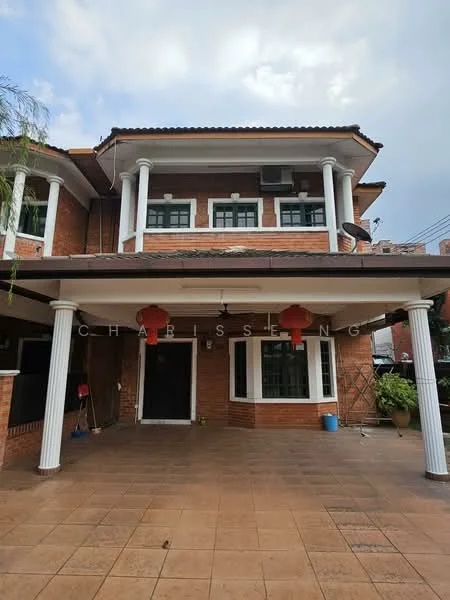 Exterior type: detached bungalow; features: brick facade, flat roof, white columns, covered porch, tiled flooring, lantern decorations, air conditioning unit visible, manicured landscaping, windows with green shutters; style: traditional.