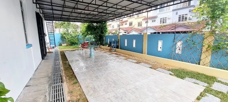 Exterior features: covered patio area, tiled flooring, landscaped garden, decorative stone pathway, fenced perimeter, outdoor seating area with chairs, greenery around the patio; style: modern.