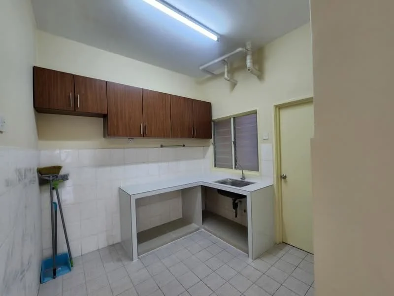 Kitchen features: laminate cabinetry in wood finish, white countertop, single-bowl stainless-steel sink, chrome faucet, white tiled backsplash, grey tiled flooring, overhead cabinets, window with horizontal slats, door leading to another room, cleaning broom, wall-mounted plumbing pipes; style: modern.
