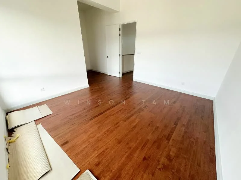 Room features: wooden flooring, white painted walls, high ceiling, doorway leading to another room, natural light from window, empty space, no visible furniture.