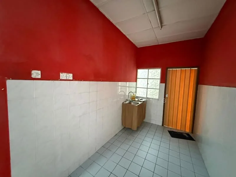 Laundry features: red painted walls, white tiled walls, grey tiled flooring, single-bowl stainless-steel sink, wooden cabinet under sink, window with grid pattern, wooden door, door mat.