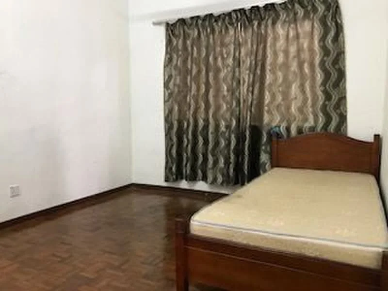 Bedroom features: single bed, wooden bed frame, mattress, brown patterned curtains, parquet wood flooring, white painted walls, window, empty space.
