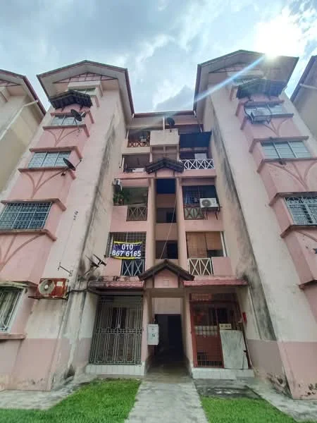 Exterior type: low-rise apartment block; features: pink painted facade, balconies with railings, air conditioning units visible, ground-level entrance, concrete walkway, manicured lawn, multiple storeys, security grille at entrance; style: traditional.