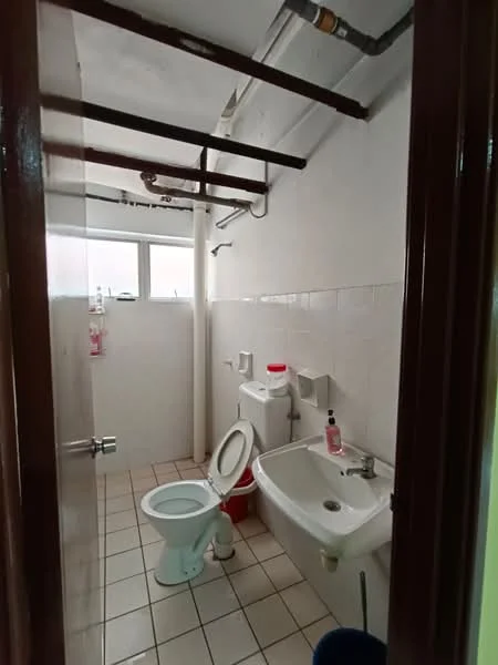 Bathroom features: white tiled walls, white ceramic floor tiles, one-piece toilet, sink with faucet, mirror above sink, window for natural light, exposed plumbing, ceiling with exposed beams.