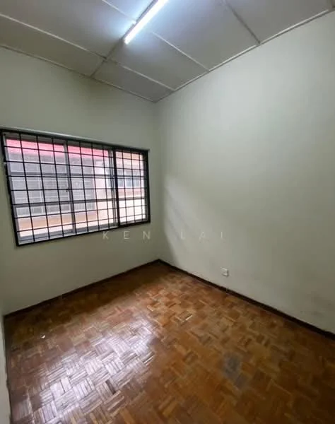 Room features: white painted walls, parquet wood flooring, single window with metal grille, ceiling light fixture, no visible furniture.