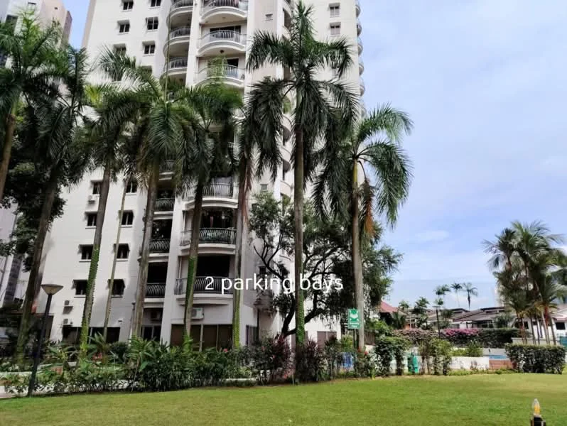 Exterior type: high-rise condominium; features: green lawn, palm trees, manicured landscaping, balconies on upper floors, 2 parking bays, surrounded by greenery, concrete facade, multiple storeys; style: modern.