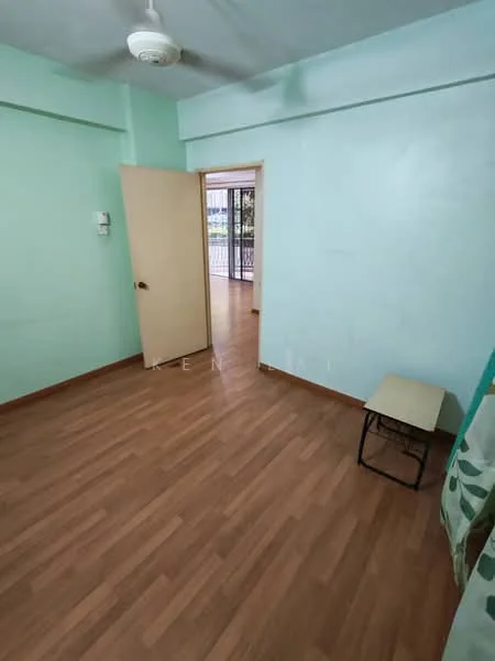 Room features: light green painted walls, laminate flooring, ceiling fan, wooden door, window with view to balcony, small stool.