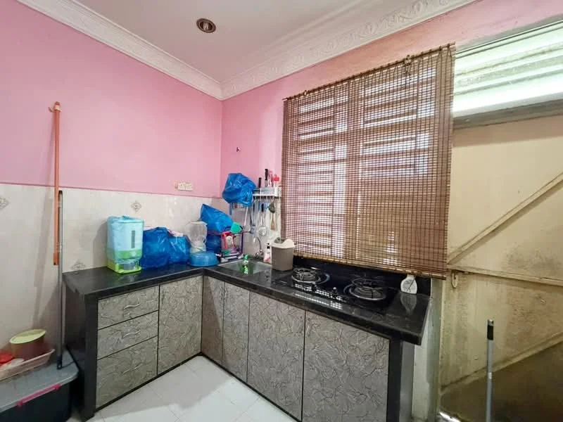 Kitchen features: pink painted walls, black granite countertop, grey textured cabinetry, double-burner gas hob, sink, bamboo window treatment, white tiled flooring, door leading outside.