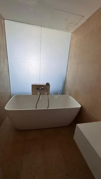 Bathroom features: freestanding bathtub, chrome faucet, neutral stone wall cladding, light-colored flooring, minimalist design, backlit mirror, modern wall-mounted faucet, large window for natural light; style: modern.
