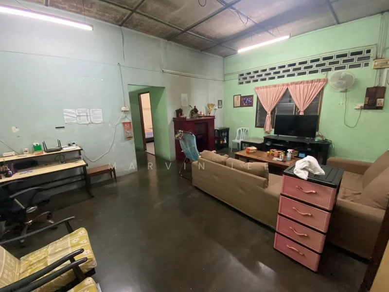 Living features: green painted walls, polished concrete flooring, sofa in beige, coffee table, TV console, wall-mounted TV, ceiling fan, window with sheer curtains, decorative artwork, study desk with chair, pink dresser. Room features: doorway leading to another room, light fixture on ceiling.