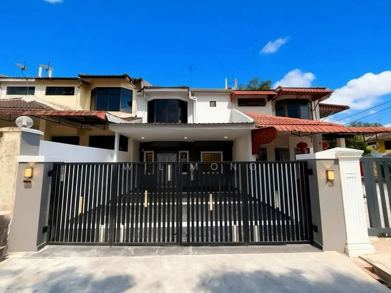 Exterior type: linked terrace house; features: black metal gate, white painted facade, red tiled roof, two-storey structure, front porch area, manicured landscaping, driveway with interlocking pavers, outdoor lighting fixtures, surrounding residential buildings, clear blue sky; style: modern.