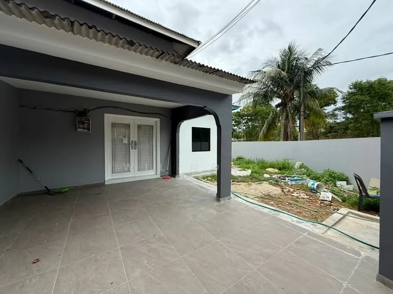 Exterior type: detached bungalow; features: grey painted facade, flat roof, paved flooring, outdoor area with garden, palm trees, fenced yard, sliding glass doors, exterior wall with window, visible landscaping, utility connections visible; style: modern.