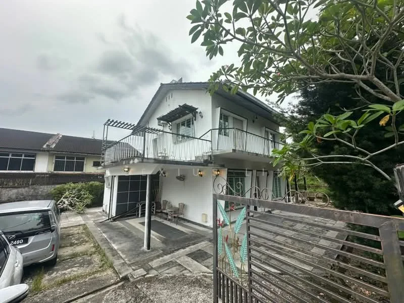 Exterior type: detached bungalow; features: two-storey building, white painted facade, balcony with railing, gated entrance, driveway with concrete paving, garden area with shrubs, carport, roof overhang, visible outdoor lighting, multiple windows, metal gate; style: modern.