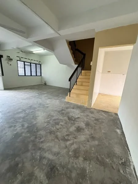 Room features: concrete flooring, white painted walls, staircase with black railing, large windows with grid pattern, open layout, high ceiling, corner wall with beige paint, no visible furniture or decor; style: minimalist.