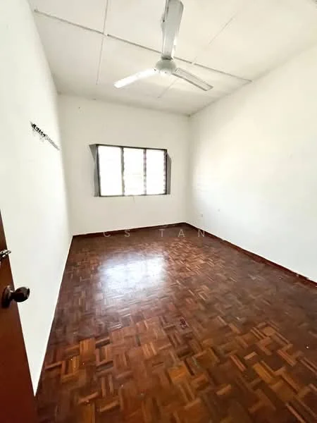 Room features: white painted walls, parquet wood flooring, ceiling fan, single window with curtains.