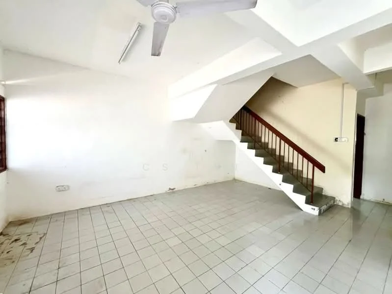 Room features: white painted walls, plain ceiling, ceiling fan, tiled flooring, staircase with wooden railing, window with grille, empty space, no visible furniture; style: minimalist.