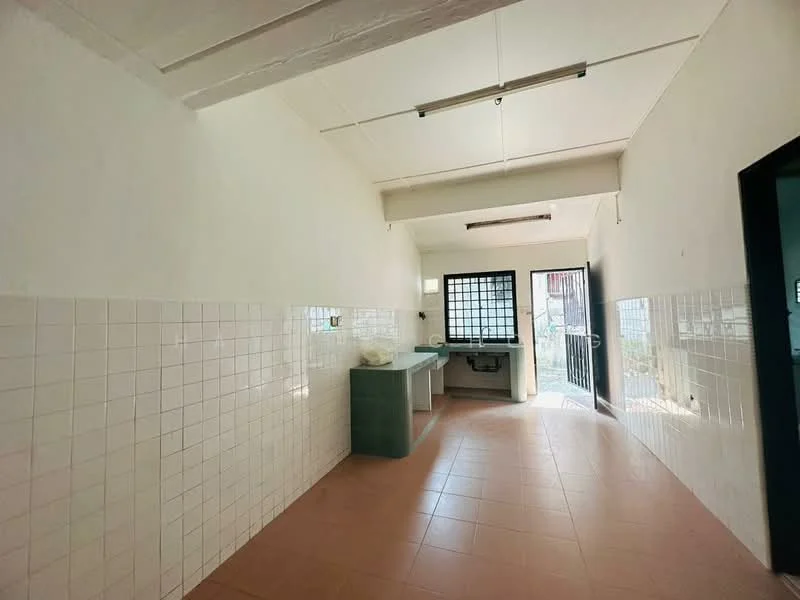 Kitchen features: white tiled walls, light brown tiled flooring, green countertop, single-bowl stainless-steel sink, window with security bars, door leading outside, overhead lighting, open layout.