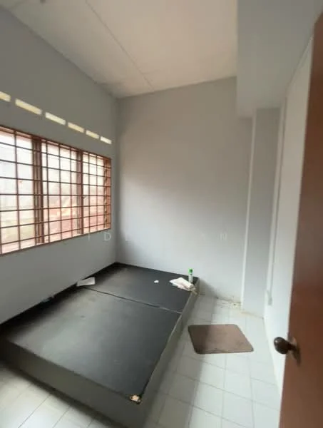 Room features: grey painted walls, white ceiling, large windows with grid pattern, black platform bed base, white tiled flooring, small brown mat, bottle on floor, cleaning cloth on bed; style: minimalist.
