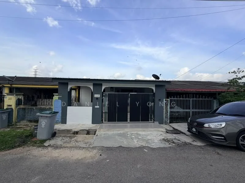 Exterior type: semi-detached house; features: grey painted facade, black metal gate, concrete driveway, single-storey, satellite dish on roof, manicured lawn, surrounded by residential area, parking space for one car; style: modern.
