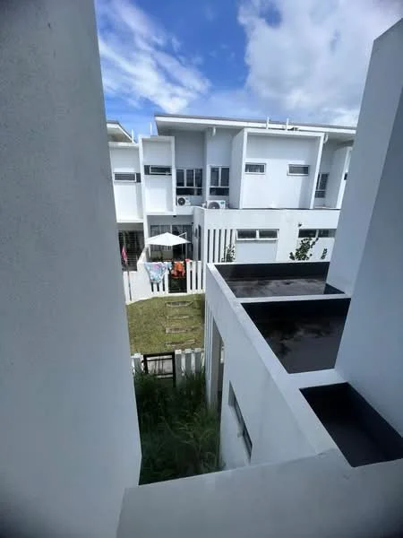 Exterior type: linked terrace house; features: white painted facade, flat roof, two-storey building, manicured lawn, outdoor dining area with umbrella, visible air conditioning units, fenced yard, landscaped garden, paved walkway; style: modern.